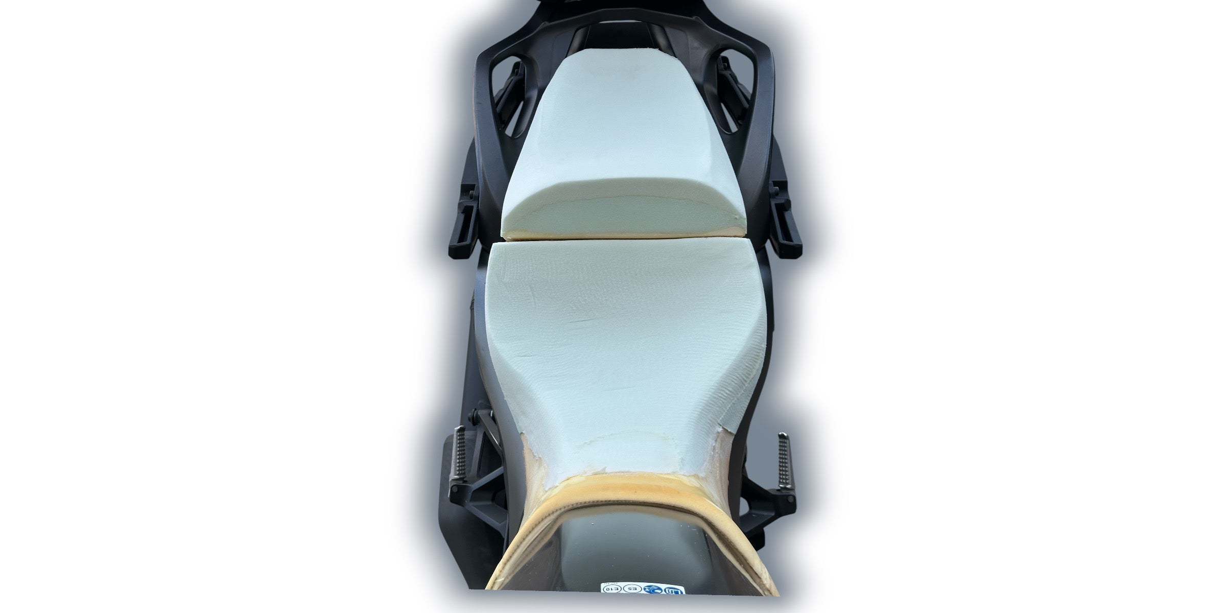 Motorcycle seat with black frame and beige cushion on a white background