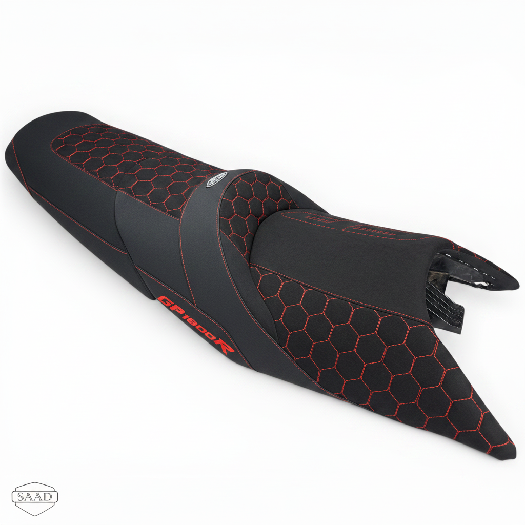 Black motorcycle seat with red stitching on a white background